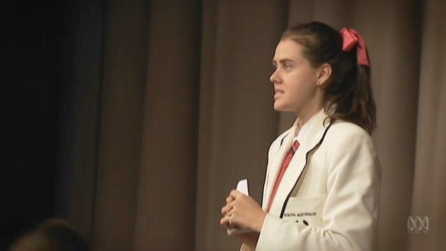 Teenage schoolgirl stands in debate