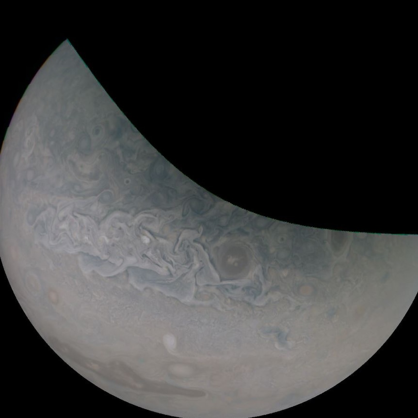 A bluish, dusty purple crescent shape on a black background.