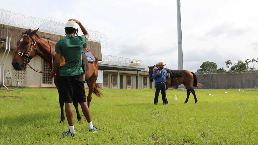 Marc Gallagher instructs a small group of young people with horses at Darwin's Don Dale youth detention centre.
