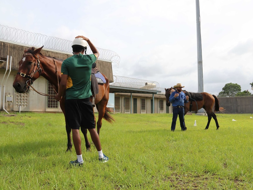 Marc Gallagher instructs a small group of young people with horses at Darwin's Don Dale youth detention centre.