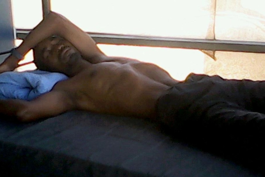 Manus Island detainee lying on bed with exposed ribs