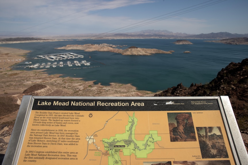 a wide image taken of an information panel with a dried-up lake in the background