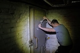 Man closes door to basement shelter