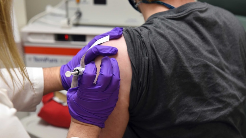 A patient is injected with a vaccine during a clinical trial.