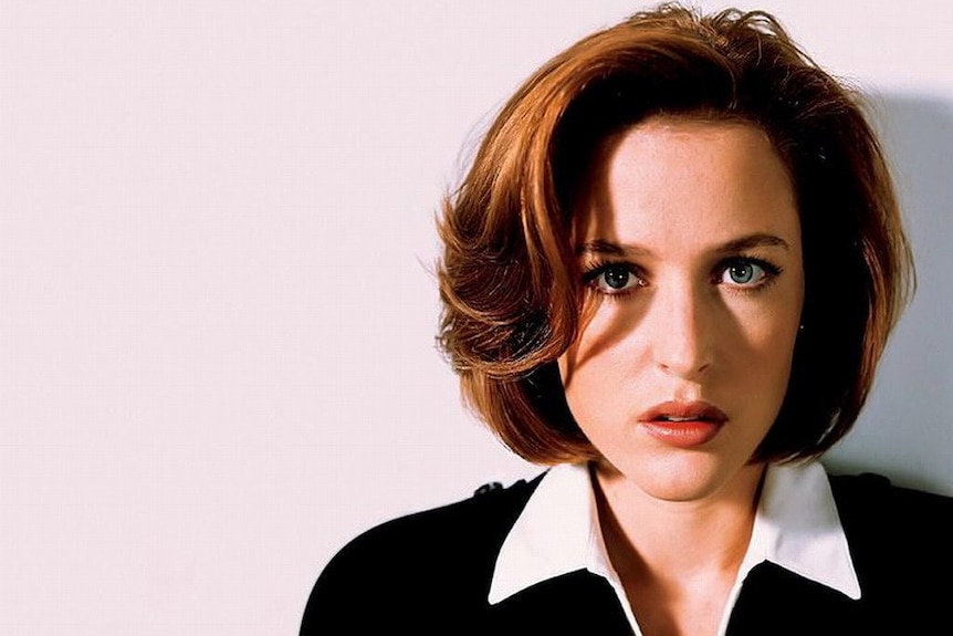 Gillian Anderson as Dana Scully stares into the camera