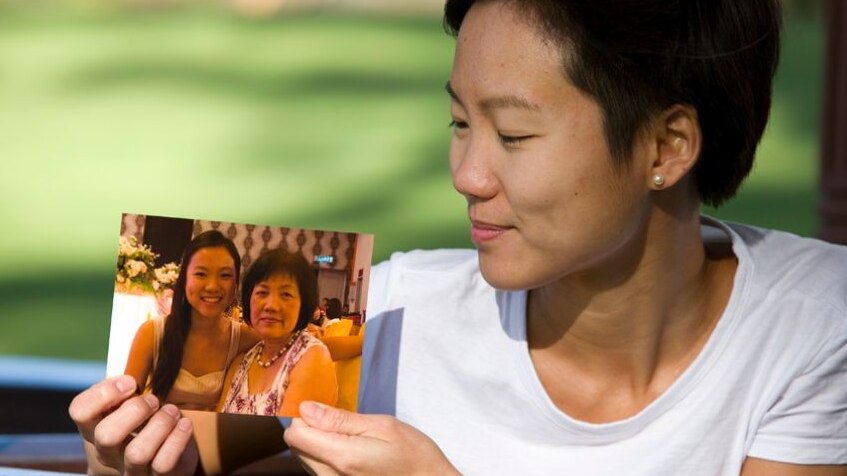 27-year-old Belinda holds a photo of her late mother.