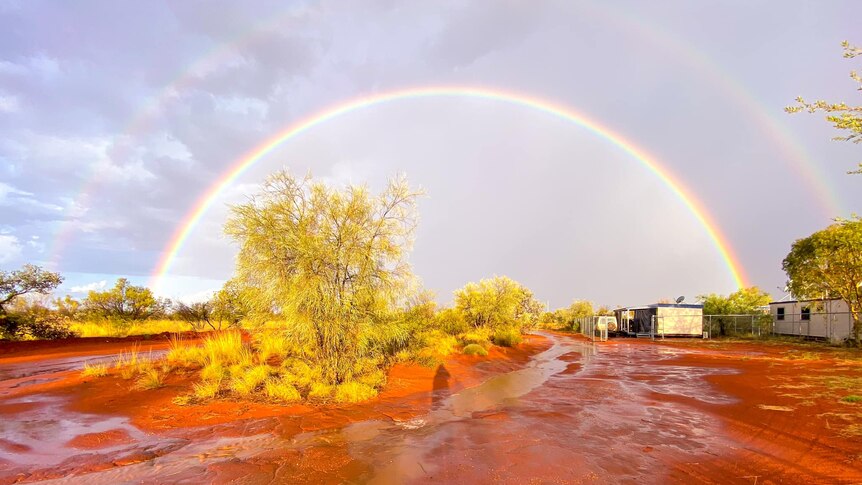 Rainbow over glistening red dirt