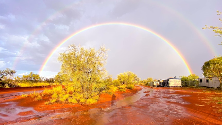 Rainbow over glistening red dirt