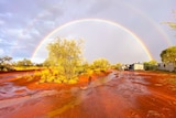 Rainbow over glistening red dirt