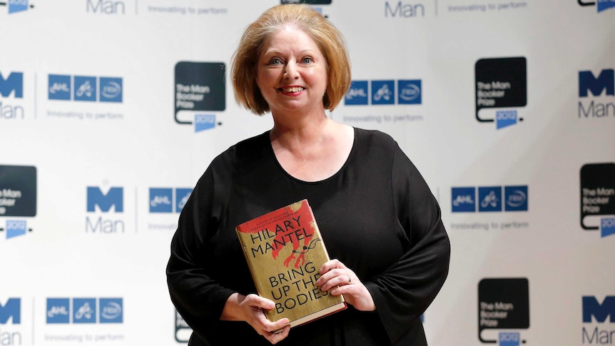 Hilary Mantel holds a copy of Bring Up The Bodies.
