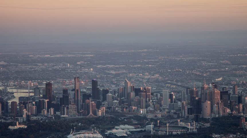 Skyscrapers and parkland viewed from the air, suburbs in background