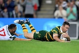 James Maloney dives over to score for the Kangaroos against Lebanon.
