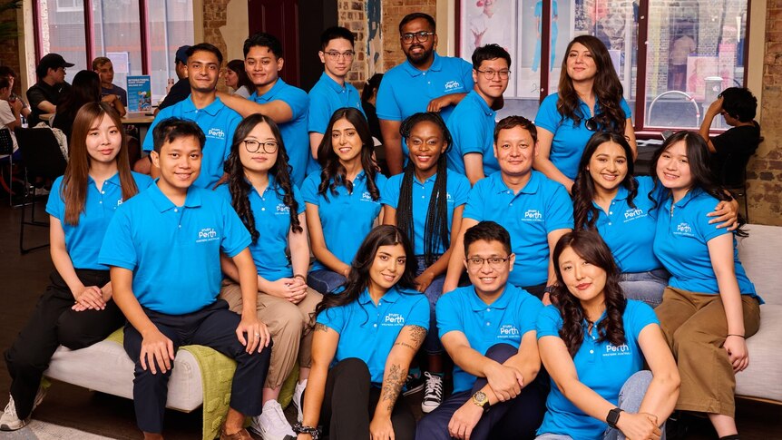 Group photo of international student ambassadors wearing blue polos.