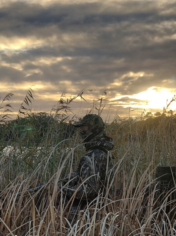 Hunter watches for signs of ducks from the reeds on the Loveday wetlands