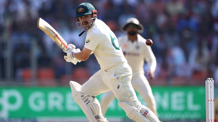 An Australian male batter scores runs against India on day one of the fourth Test against India.