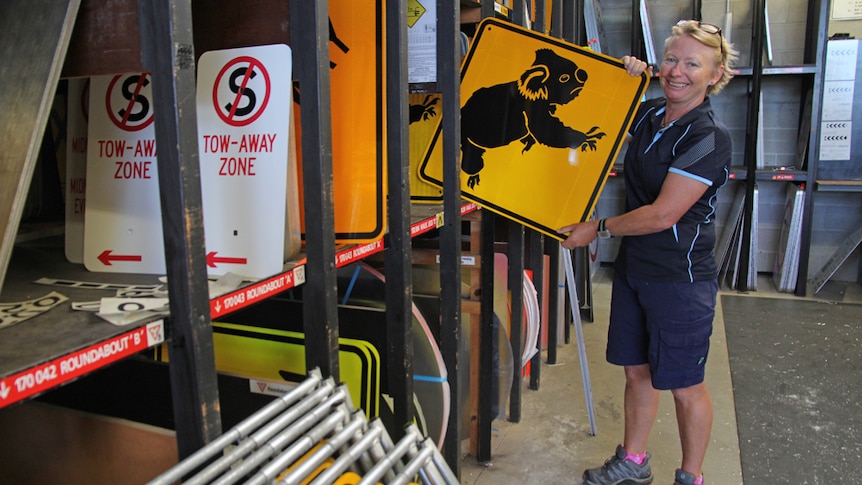 Gold Coast sign writer Jennifer Slough in the council storeroom