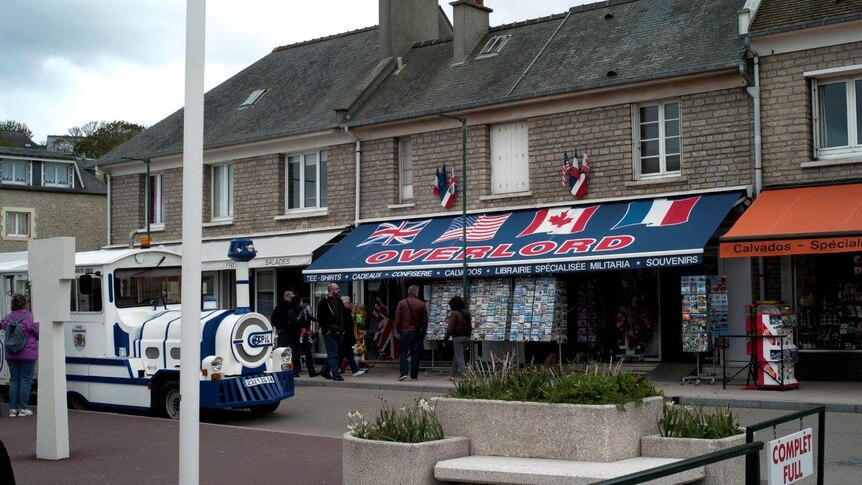 The “Overlord” souvenir store, one of many war-themed stores and restaurants in Normandy, with tour train parked out front.