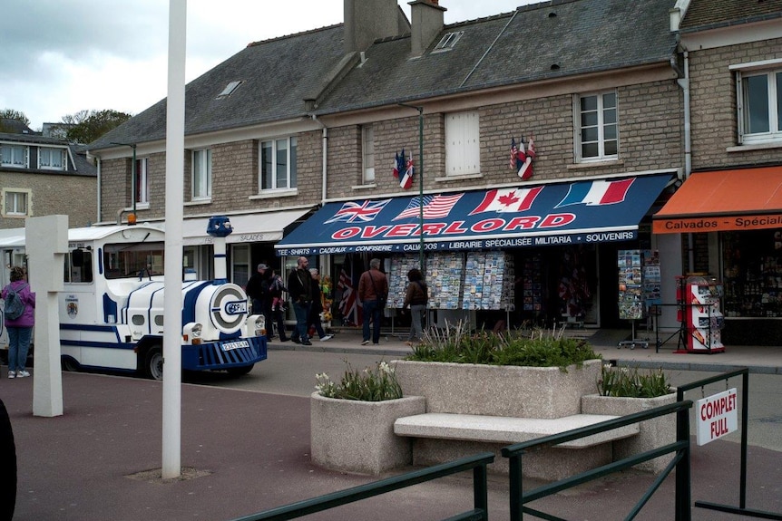 The “Overlord” souvenir store, one of many war-themed stores and restaurants in Normandy, with tour train parked out front.