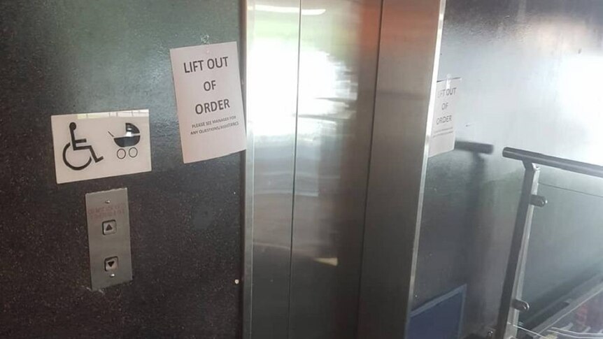 A sign reads Lift out of Order in front a lift with a wheelchair sign beside it.
