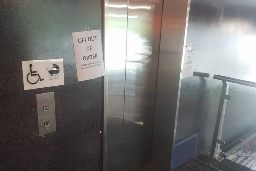 A sign reads Lift out of Order in front a lift with a wheelchair sign beside it.