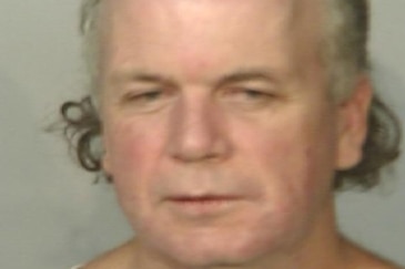 Closeup of a man that could be a mugshot.