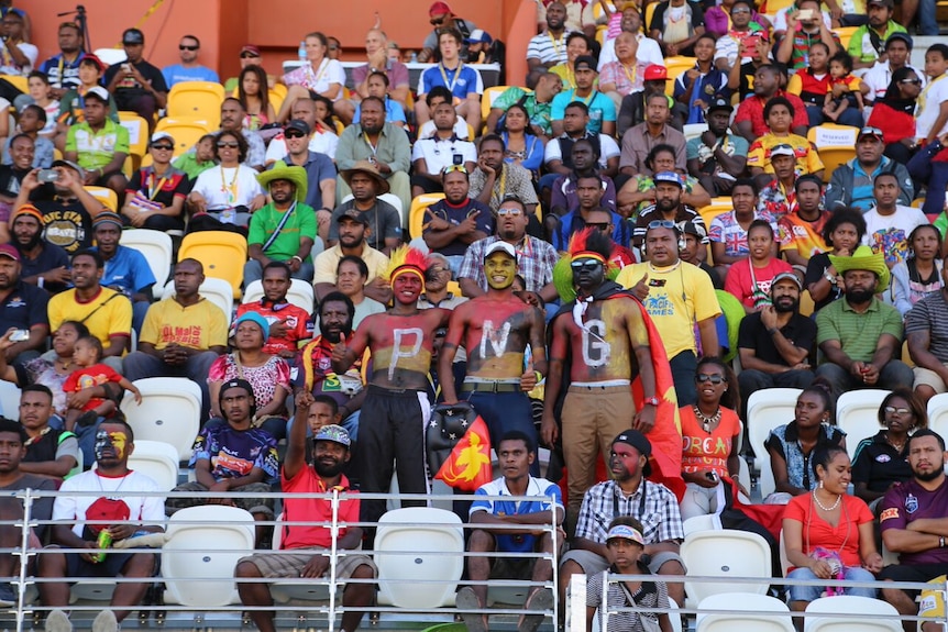 Supporters cheer on the Papua New Guinea rugby nines
