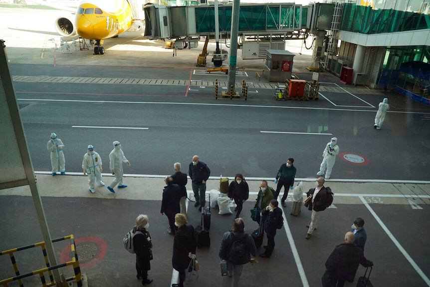 Members of the WHO team gather after arriving at the airport in Wuhan in central China's Hubei province.