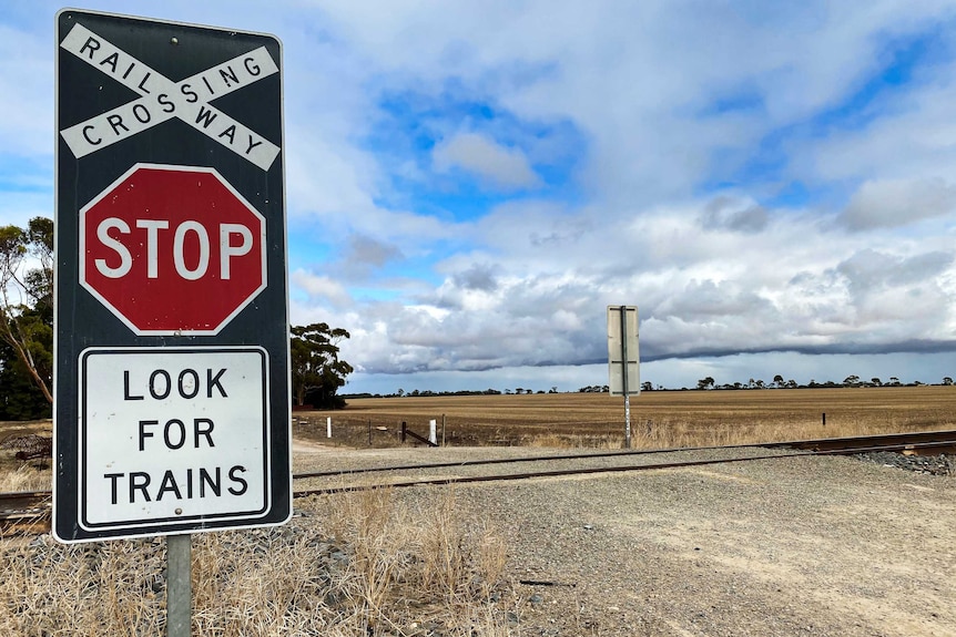 a stop sign at the level crossing