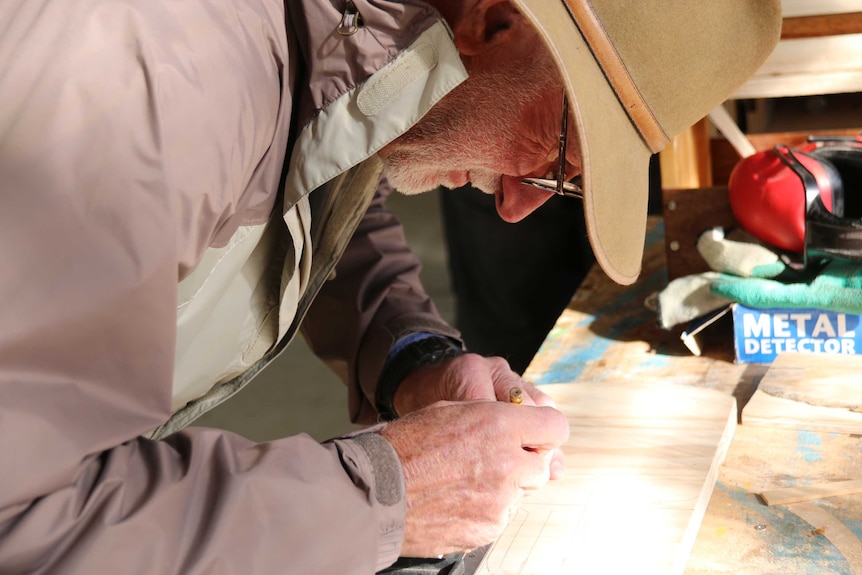 A man works in the Majura Men's Shed.