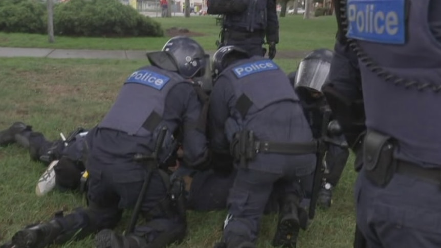 Police arrest a man at Coburg rally