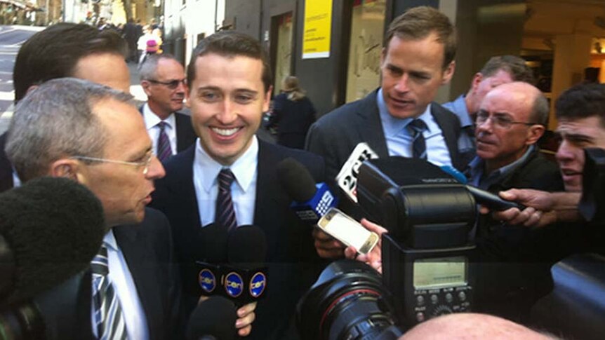 Tom Waterhouse smiles as he arrives at a stewards' inquiry