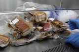 Processed meat in clear packaging seized by staff at airports.