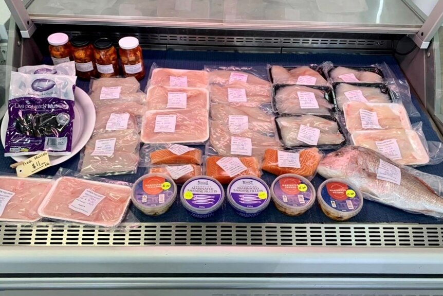 a display of seafood, some is packaged 