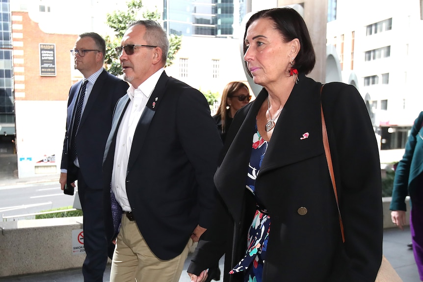 Lloyd Clarke (center) and Sue Clarke (right) arrive to the inquest into the death of Hannah Ashlie Clarke