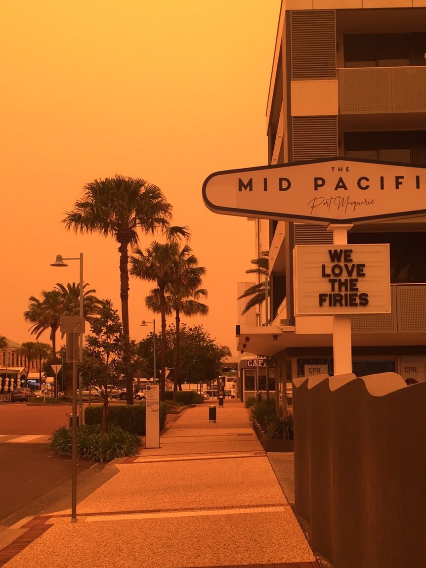 The corner of the Mid pacific Hotel in Port Macquarie set against an orange sky due to bushfires.