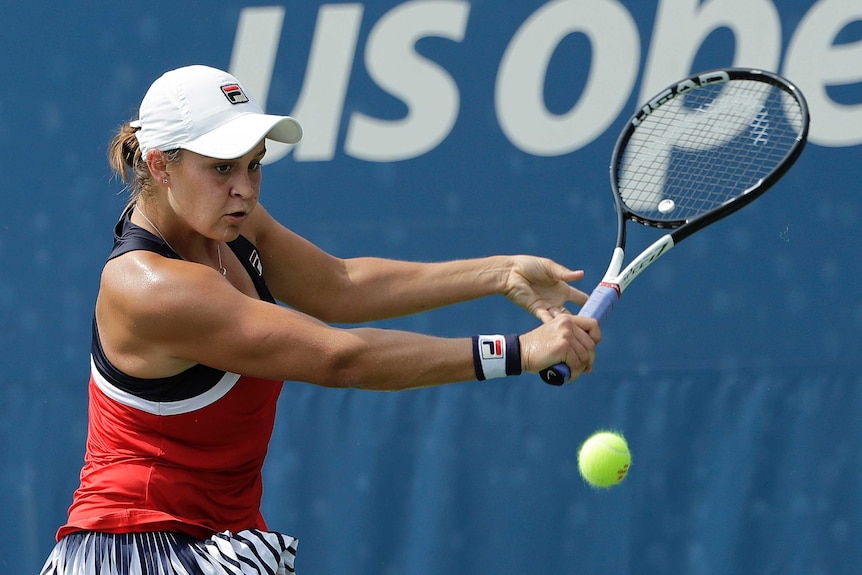 Ashleigh Barty returns a shot to Ons Jabeur ikn the first round of the 2018 US Open.