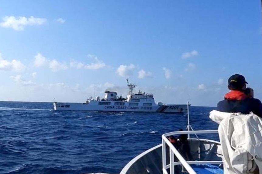 A photo of a white ship from the China Coast Guard in the ocean on a sunny day.