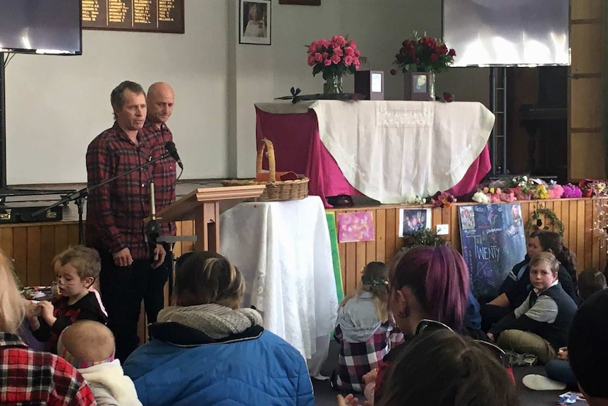 Clifford Brewer speaks at his daughters' funeral service