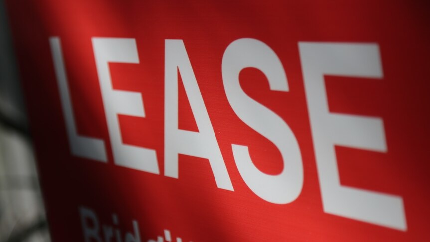 close up for lease rental sign white text on red background
