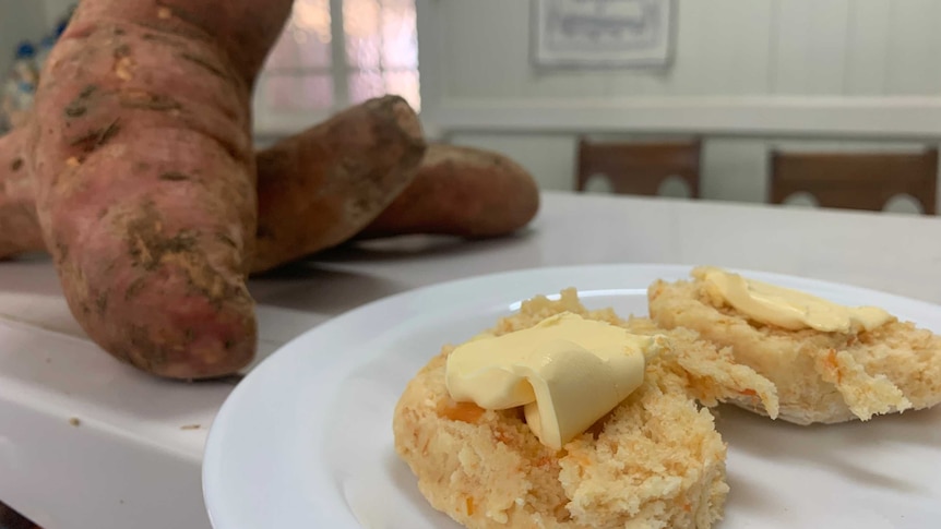 Sweet potato scones and butter with fresh sweet potatoes in the background