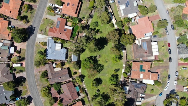 An aerial view of parks, roadways and rooftops