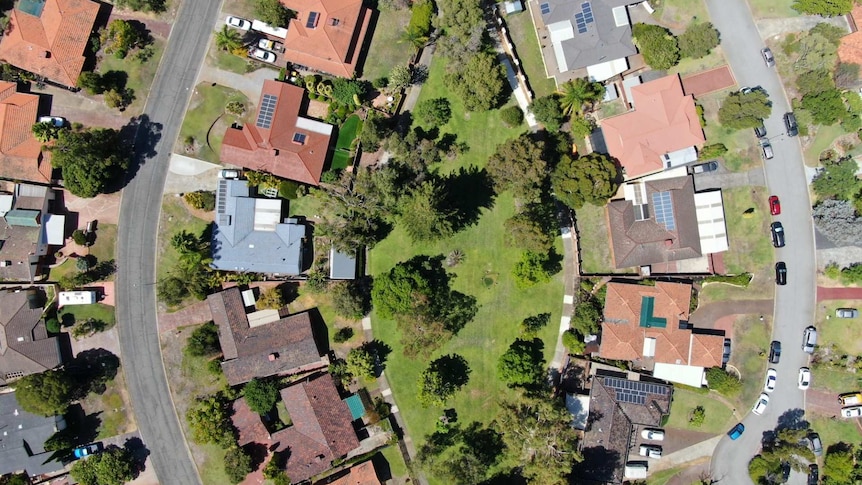 An aerial view of parks, roadways and rooftops