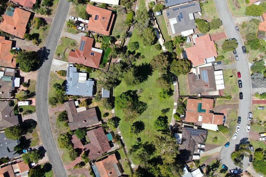 An aerial view of parks, roadways and rooftops