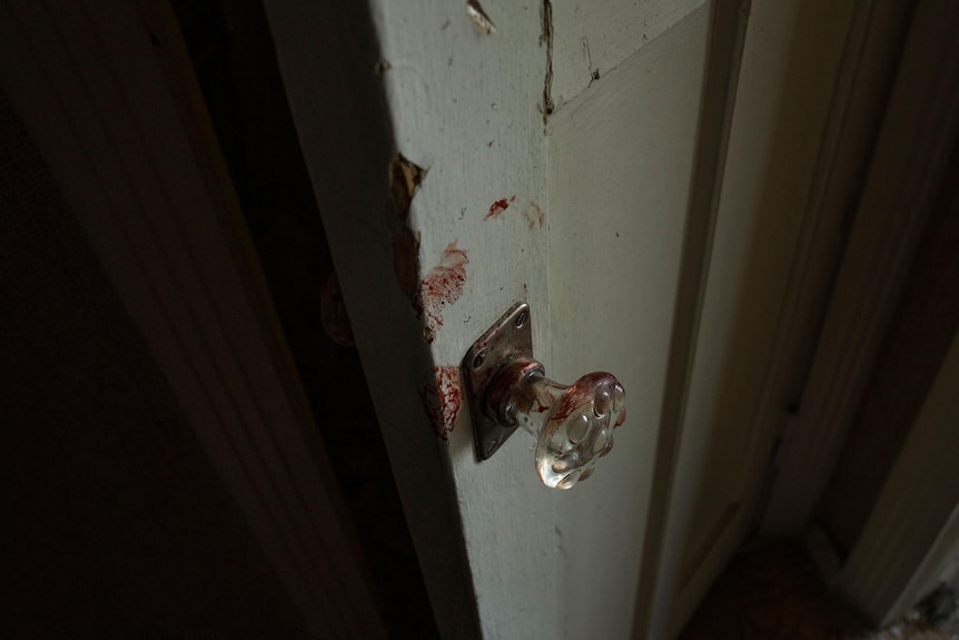 blood smeared on a glass door handle