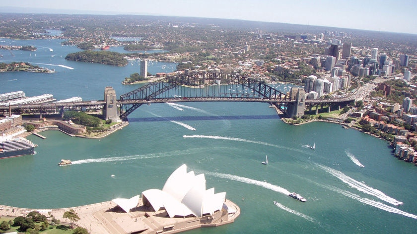 A aerial photo of Sydney Harbour with the Harbour Bridge and Opera House in shot.