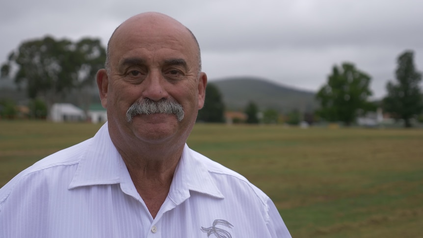 A man standing in a green field.