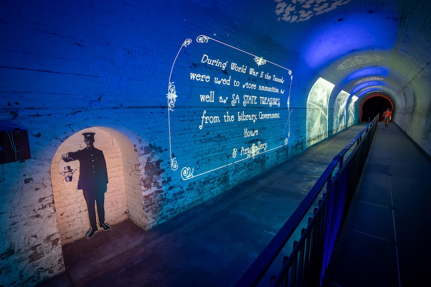 Historic photos and history about World War II projected on tunnel walls