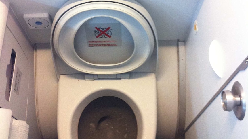 A photo of an airplane toilet