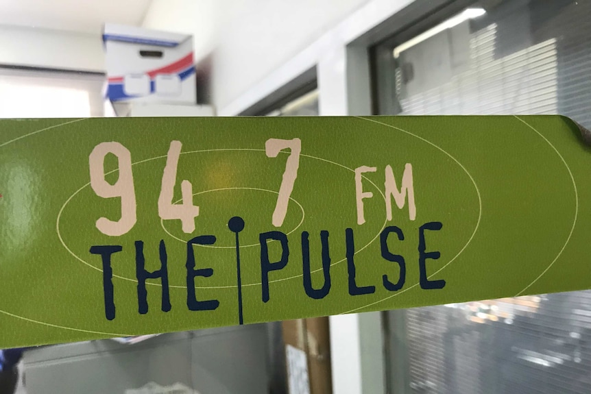A logo on a window for Geelong community radio station.