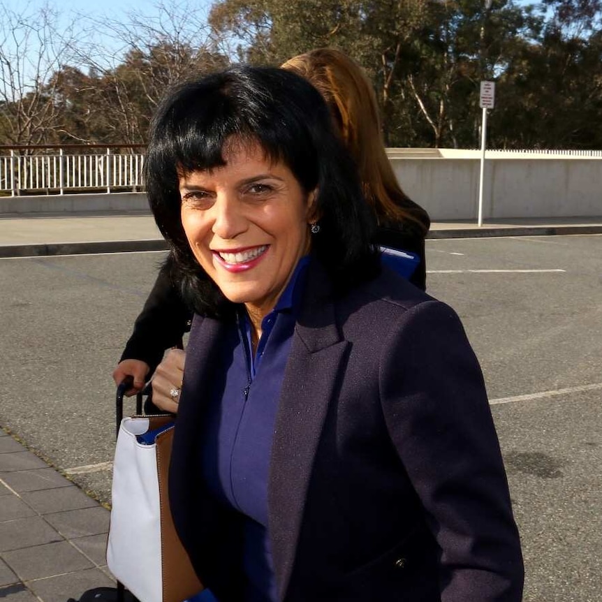 Julia Banks smiles as she arrives at Parliament House.
